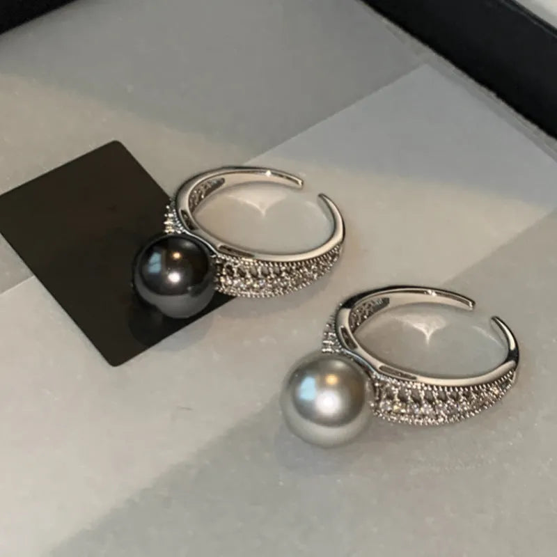 Adjustable open-ended copper ring for women in a geometric shape on a finger.