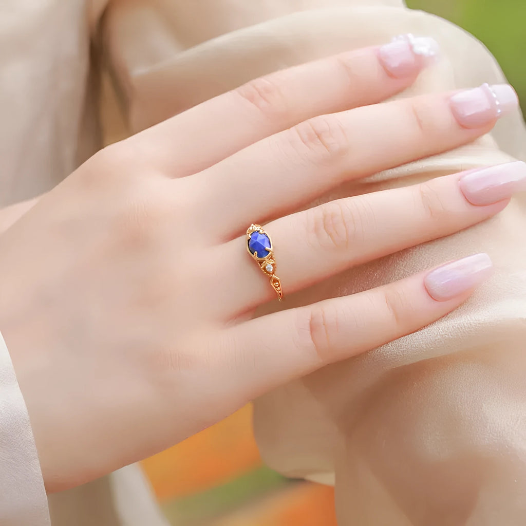 Elliptical silver alloy ring with a natural blue lapis lazuli gemstone for women.