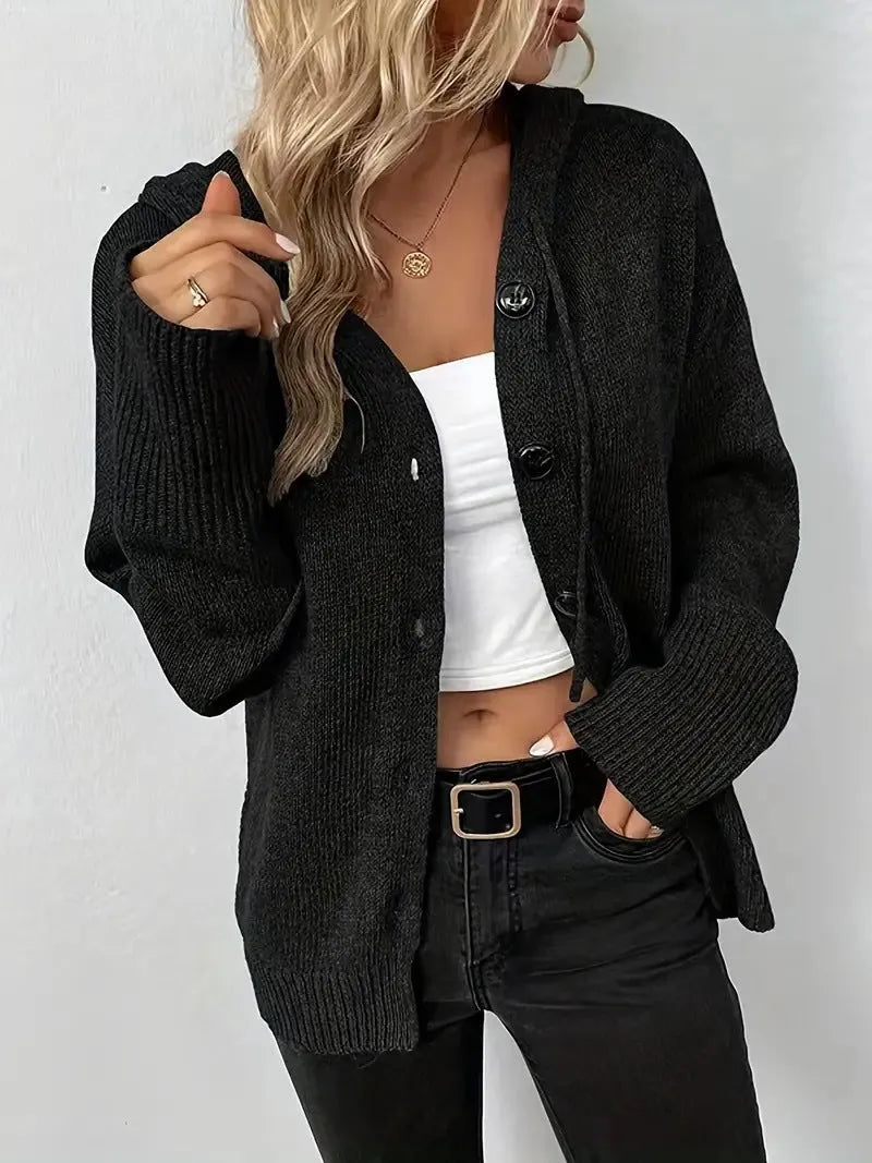 Solid colour hooded cotton cardigan sweater with loose fit and long sleeves on a hanger.