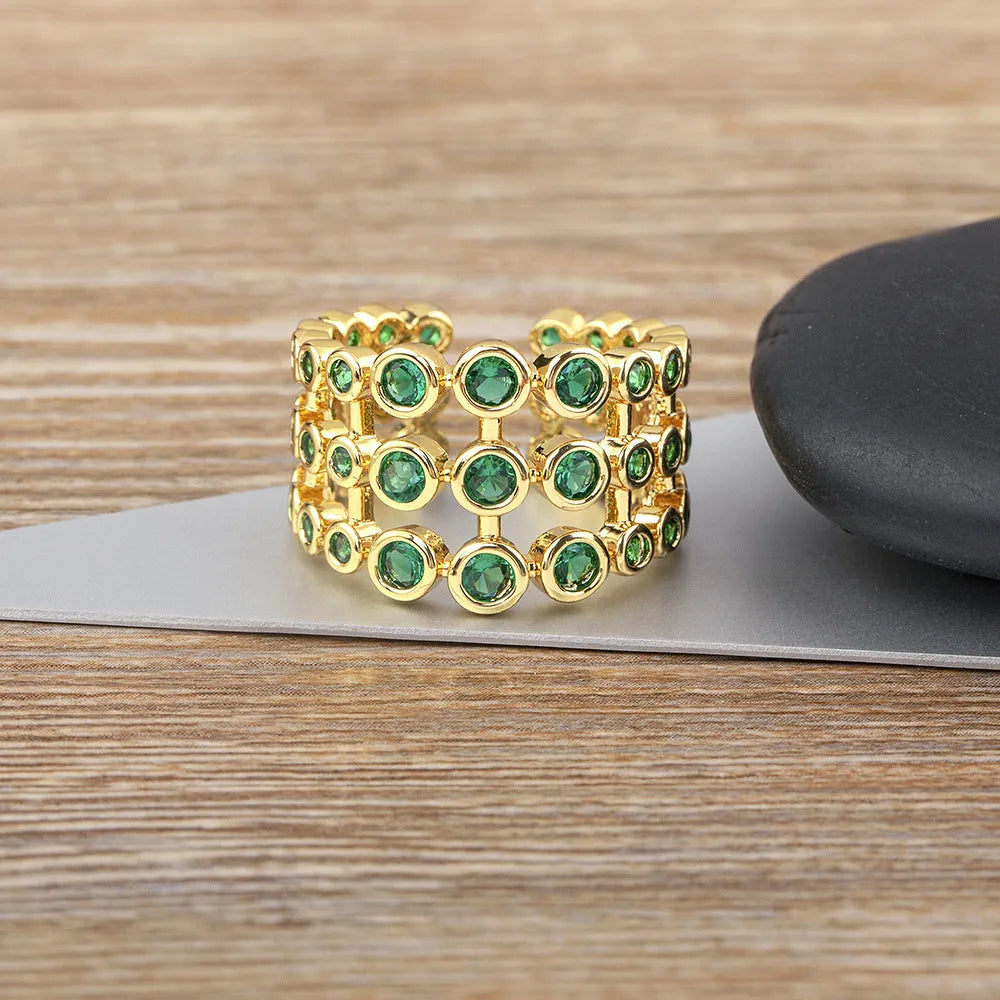 Copper ring with gold plating and green zircon stones on wide band