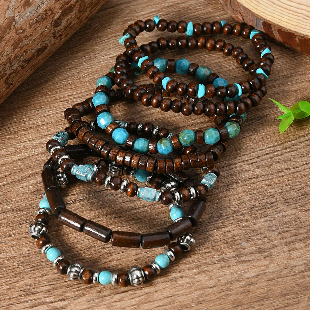 Set of seven multicolour retro bracelets with wooden beads and alloy charms laid flat.