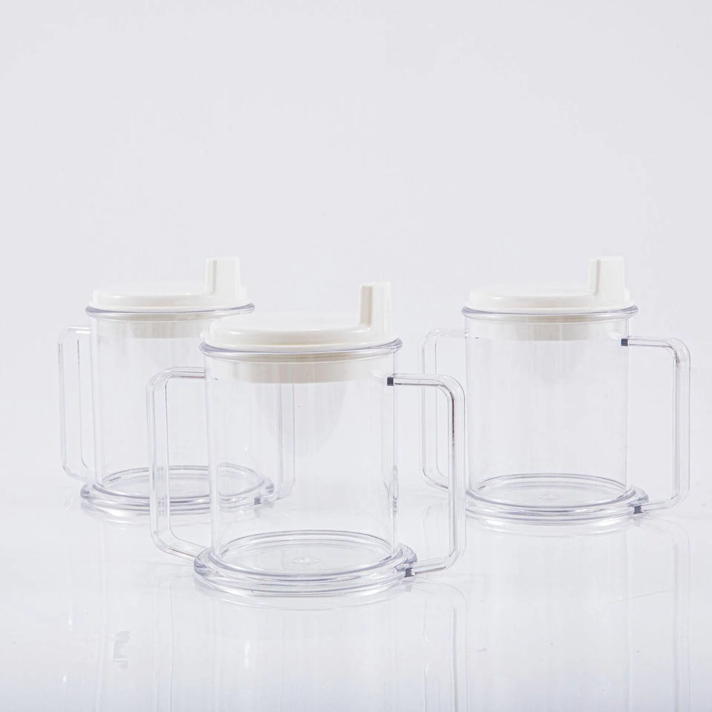 Transparent spill-proof lightweight plastic drinking cup on a table.