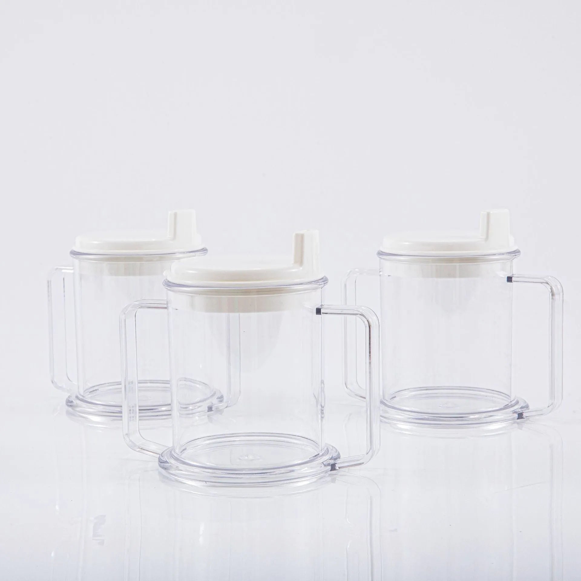 Transparent spill-proof lightweight plastic drinking cup on a table.