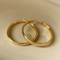 A pair of large gold-coloured metal circle earrings measuring 40mm in diameter