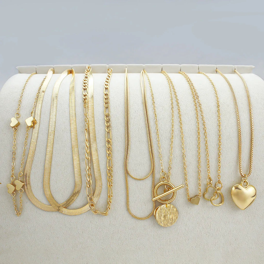Ten gold electroplated women's necklaces with alloy pendants on snake bones chains