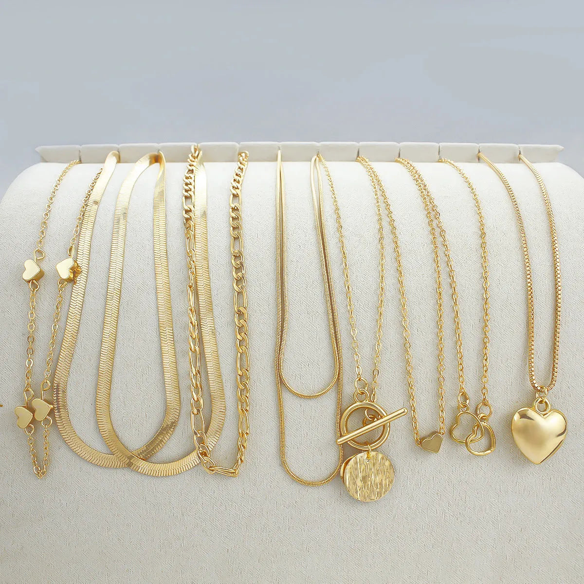 Ten gold electroplated women's necklaces with alloy pendants on snake bones chains