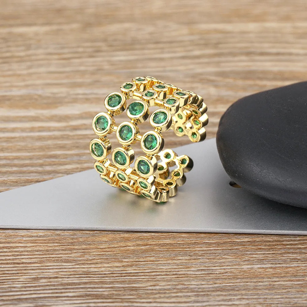 Copper ring with gold plating and green zircon stones on wide band
