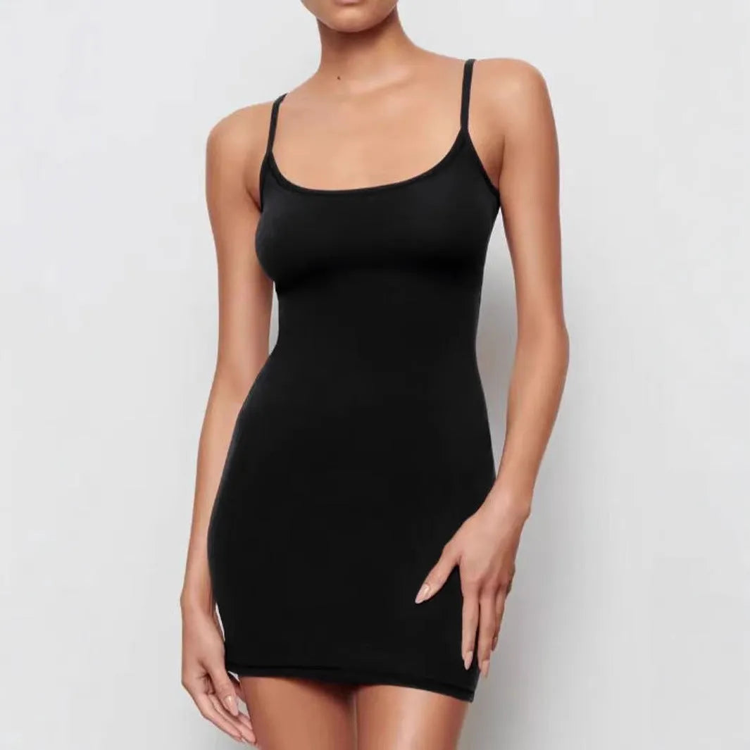 Black sleeveless sling dress with a skinny sheath fit and short skirt.