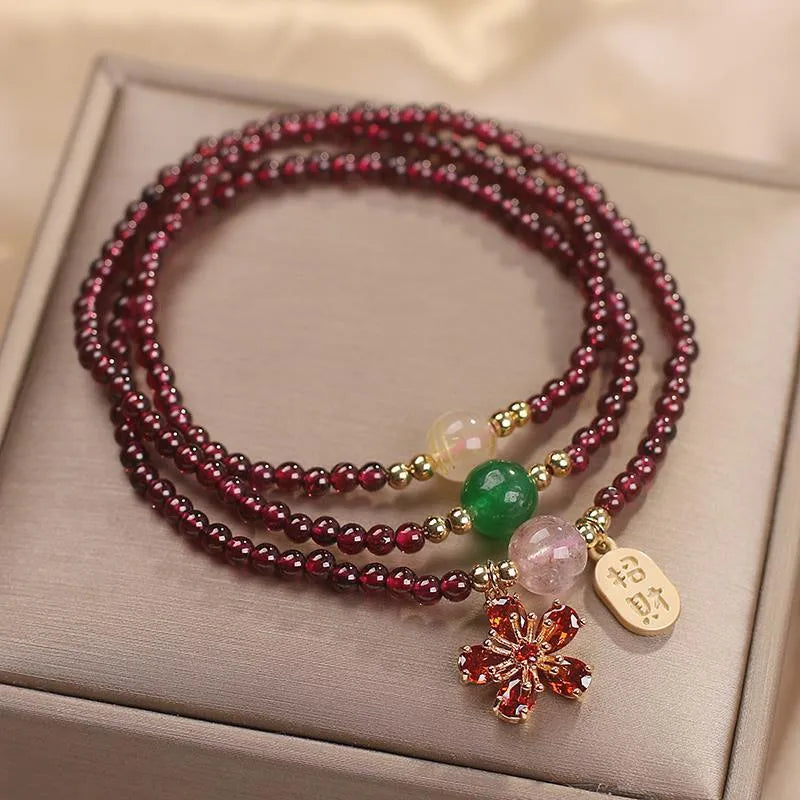 Women's natural crystal bracelet in pomegranate red cherry blossom colour with sequins detailing