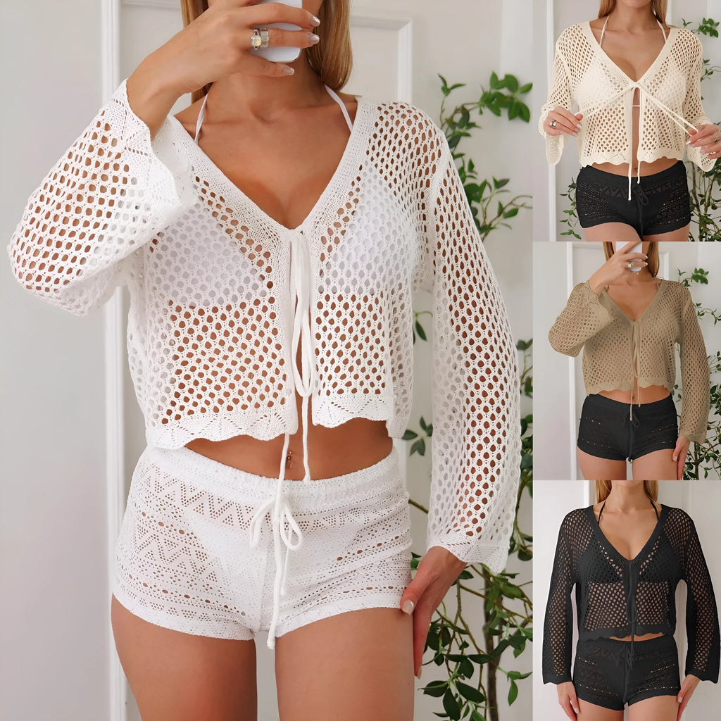 Short apricot coloured women's cardigan blouse with flared bell sleeves, laid flat.