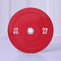 Macaron elastic rubber weight plate in blue 20kg with large centre hole on a gym floor