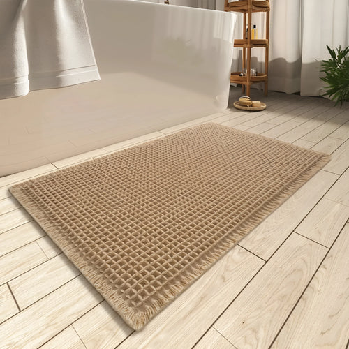 A beige checkered non-slip polyester bathroom carpet on a tiled floor.