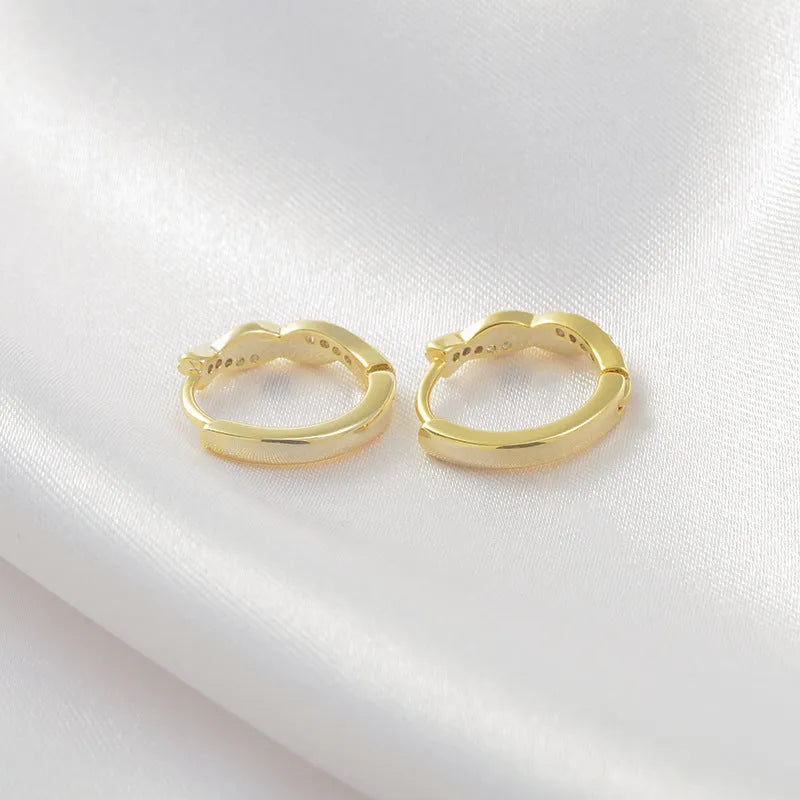 Geometric interwoven hemp rope earclip earrings in a gold or silver copper finish.