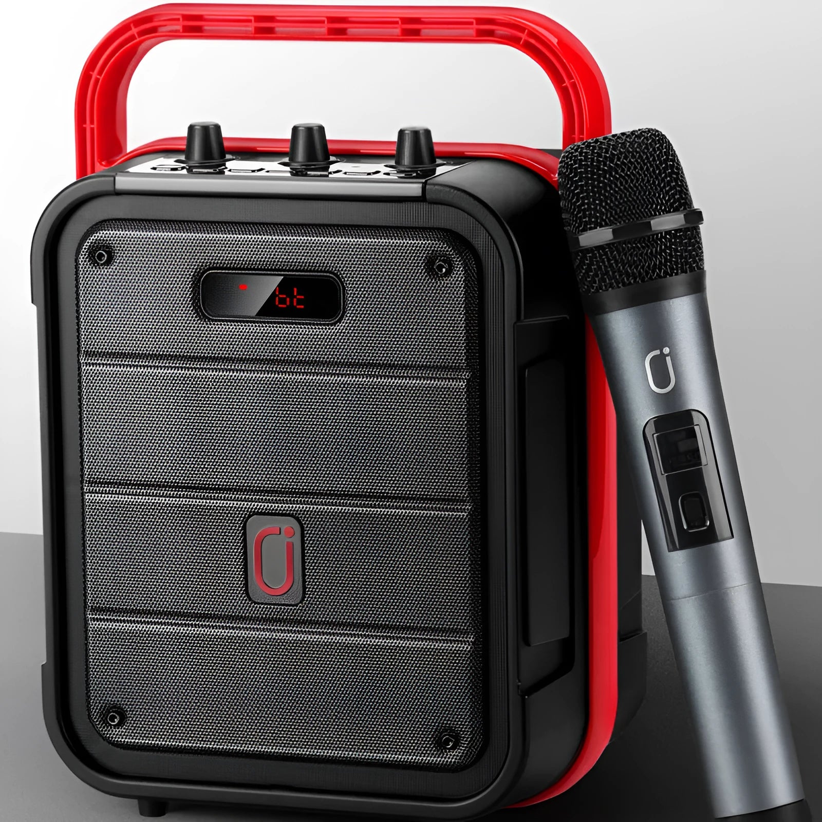 MS62AI portable Bluetooth karaoke speaker with wireless microphone and remote control on table.