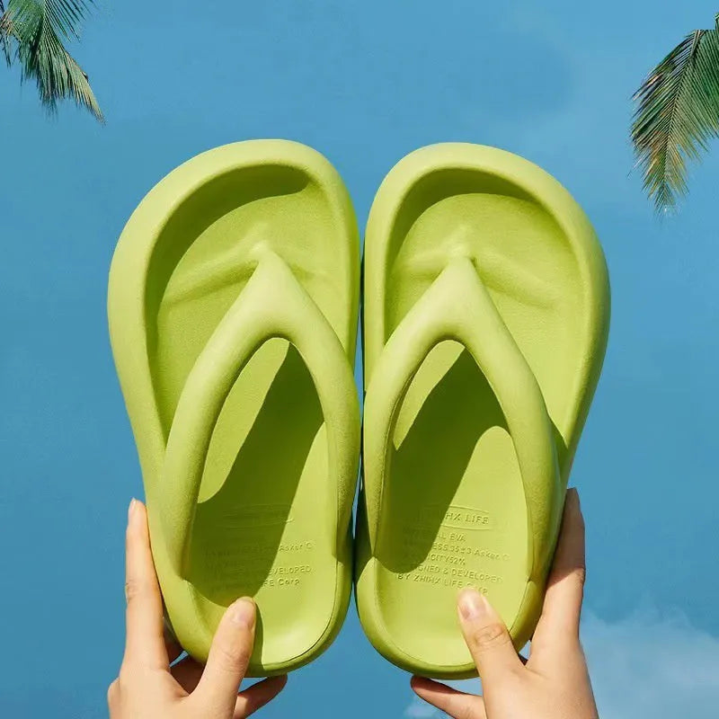 A pair of solid-colour thick-soled EVA flip-flops with a decorative bow on the thong strap.
