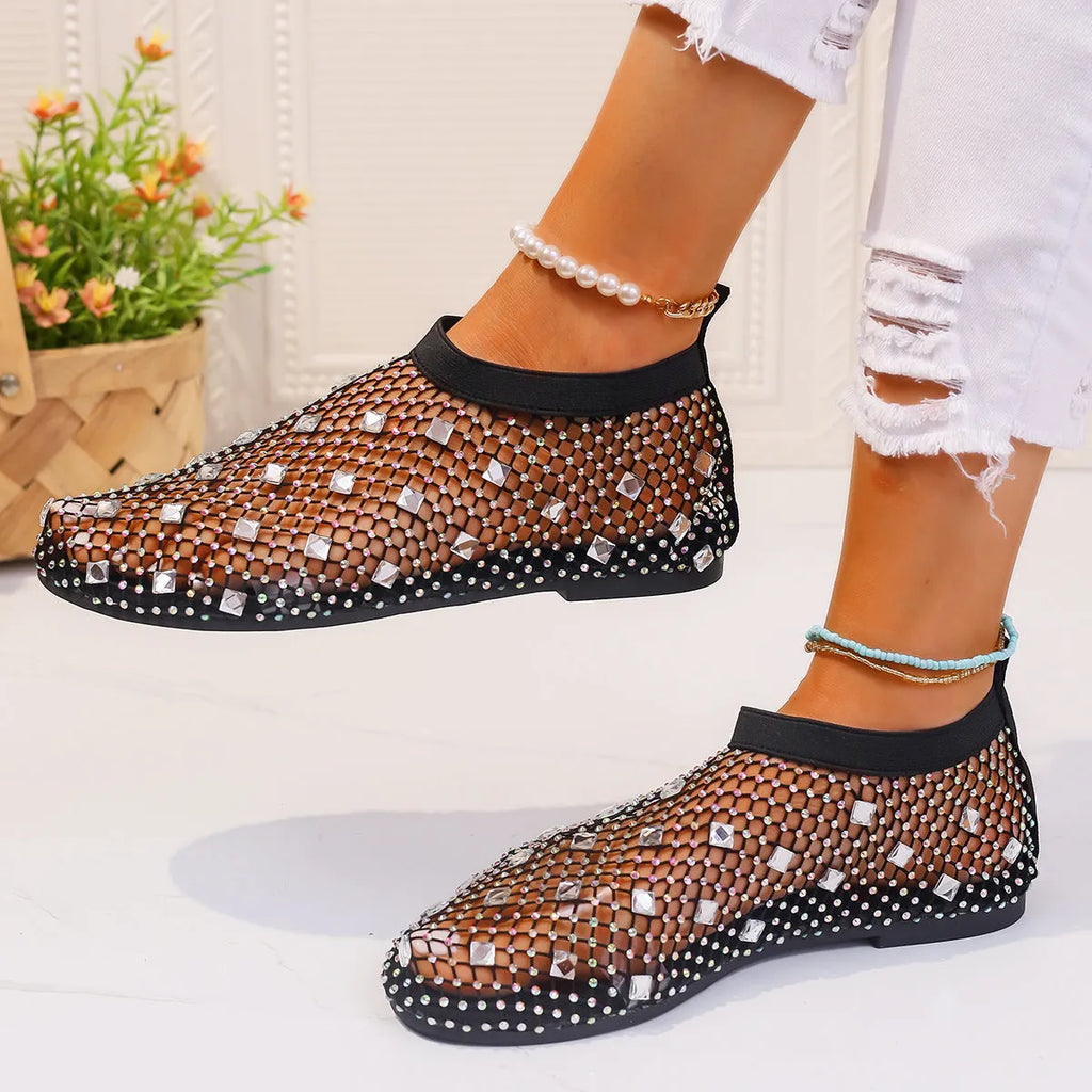 Women's flat sandals with a colourful rhinestone design on a breathable mesh upper and a rubber sole.