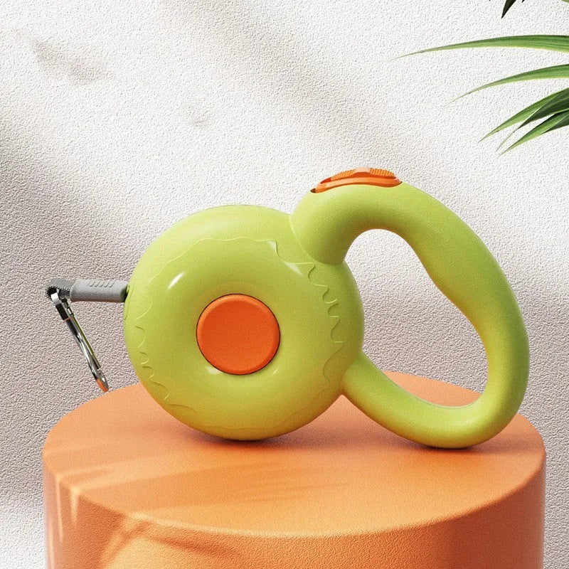 Retractable dog leash with reflective rope in green colour on a wooden floor