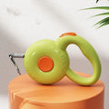 Retractable dog leash with reflective rope in green colour on a wooden floor
