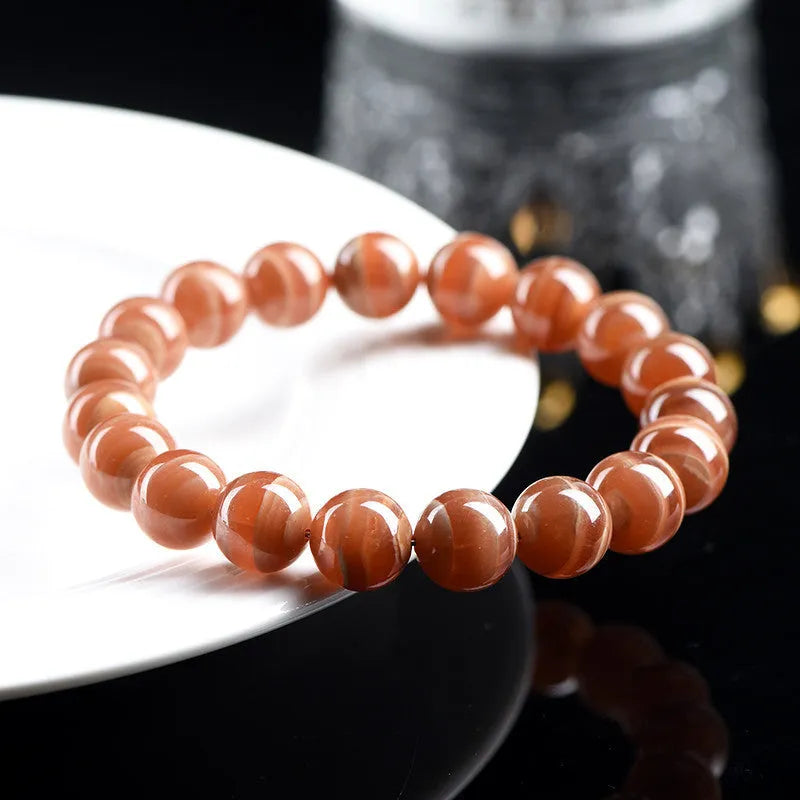 Natural old mine rhodochrosite round bead bracelet from Peru with ruyi charms.