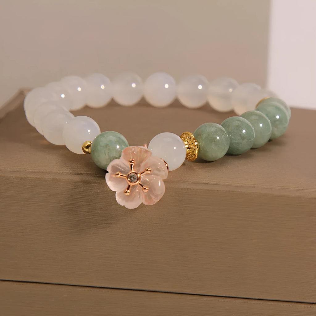 Women's floral bracelet made of white agate and jadeite stones set in jade.