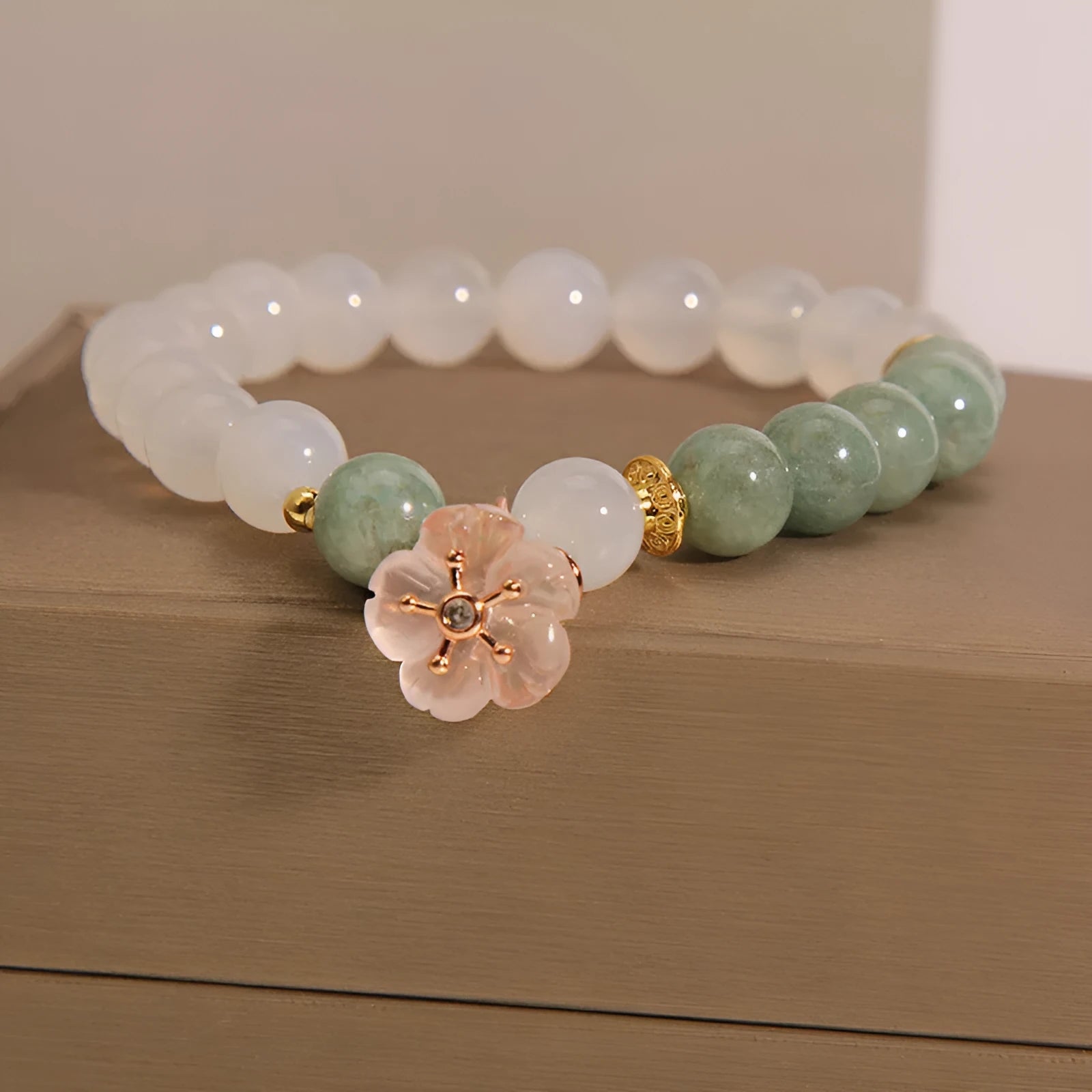 Women's floral bracelet made of white agate and jadeite stones set in jade.