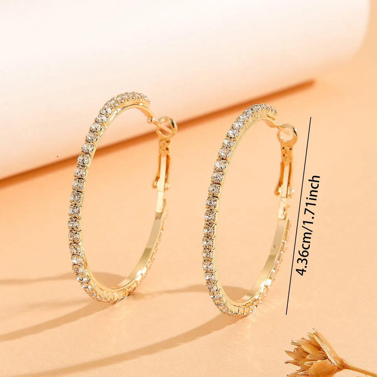 Large gold plated copper zircon hoop earrings for women, princess style, gold colour, on white background