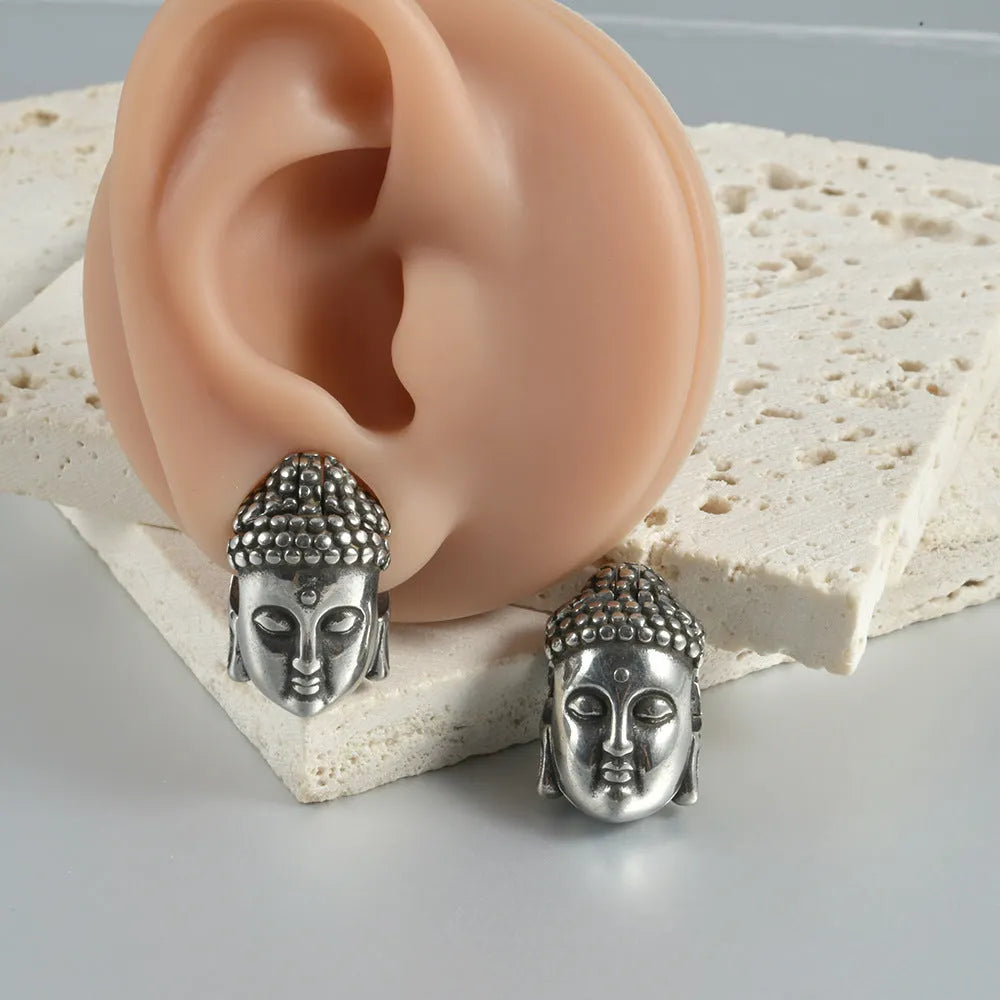 Stainless steel hollow skull Buddha earring in geometric hip hop style.