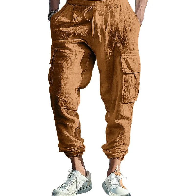 Man wearing loose-fit khaki linen casual trousers with ankle ties and multiple pockets.