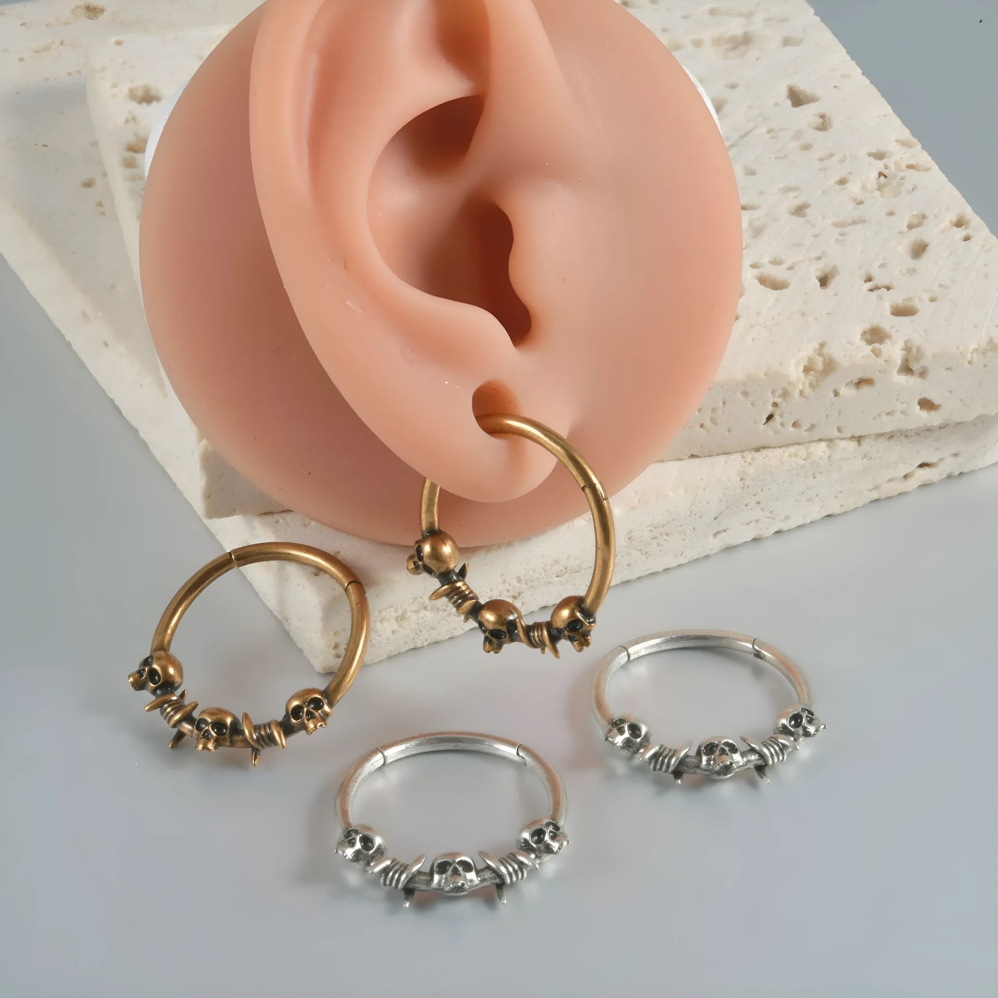Close-up of handcrafted copper punk earrings with detailed vintage ghost head pendants on a 7cm drop wire.