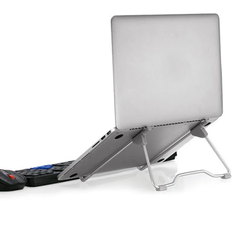 Space grey aluminium alloy adjustable stand holding a mobile phone and a laptop on a desk.
