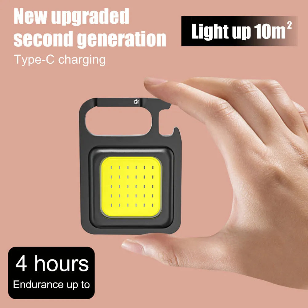 Mini portable COB keychain flashlight with USB recharge, 400 lumens, and built-in bottle opener