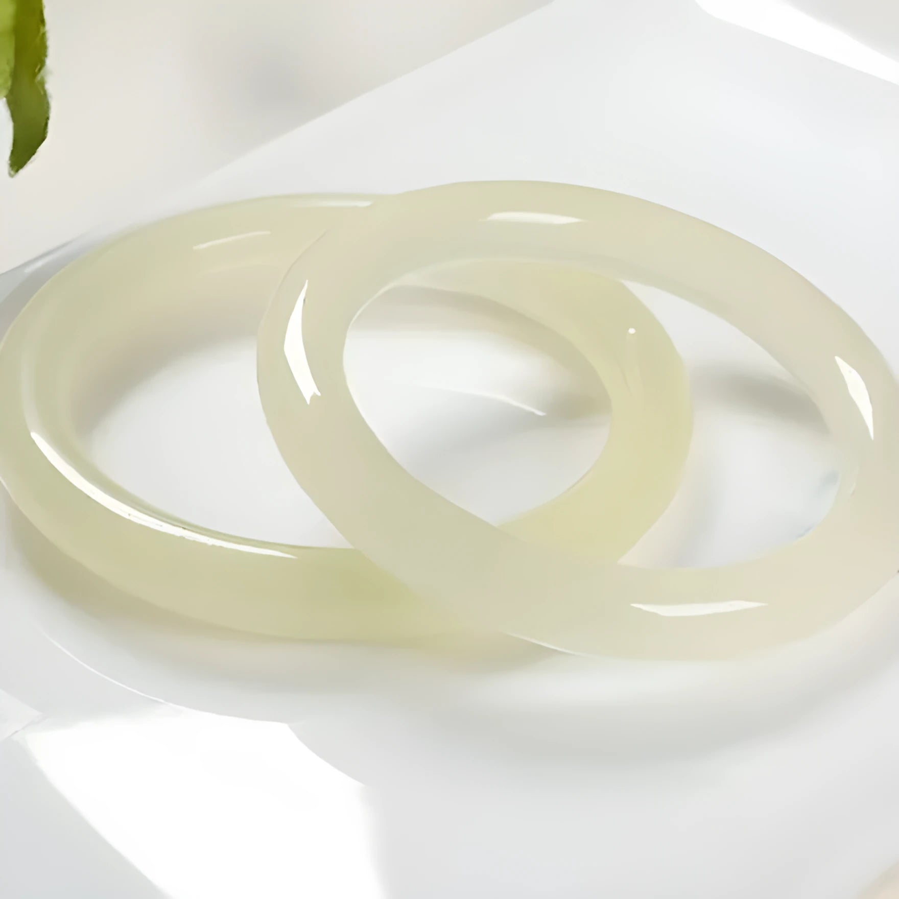 Ice-like silk jade round bar bracelet showing smooth stone surface and circular form