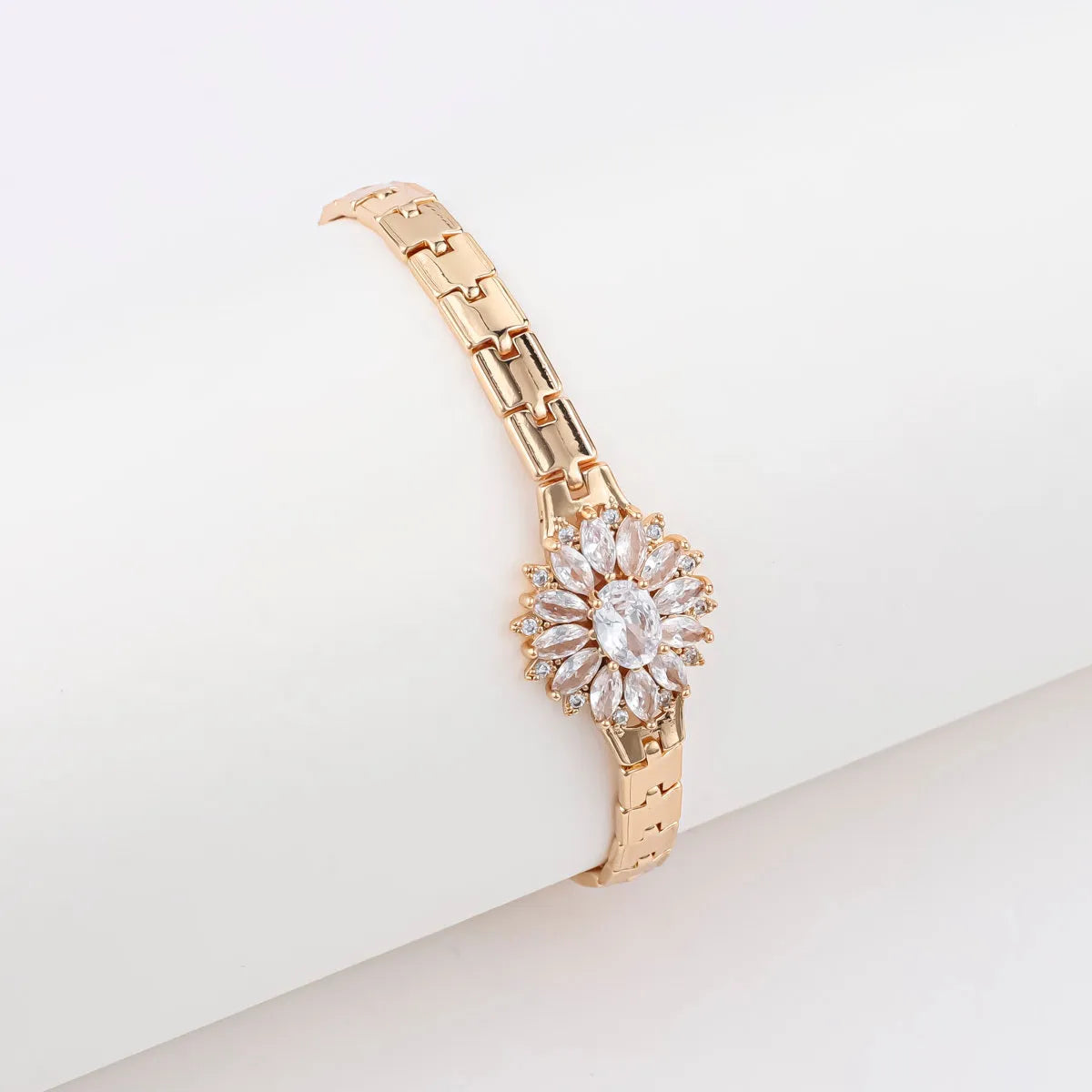 18K gold-plated butterfly clover brass bracelet with zircon stone on plain background