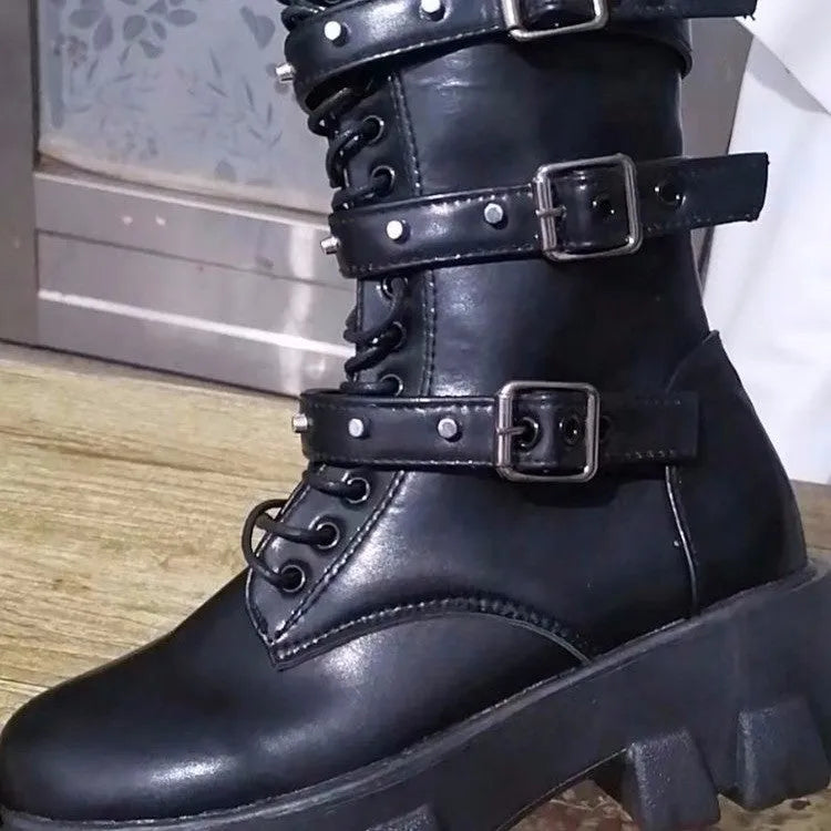 A pair of black women's mid-calf boots with a side zip and a round toe, showing the metal buckle detail.