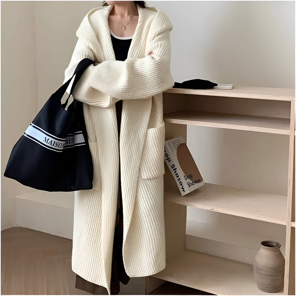 Loose-fitting beige hooded cardigan coat for women with raglan sleeves on a hanger.