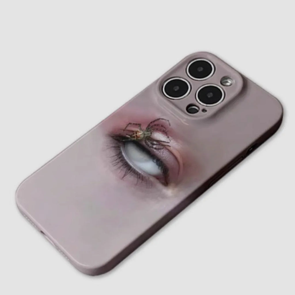 Dark heterochromatic spider design resin case for iPhone 15 Pro Max on a table