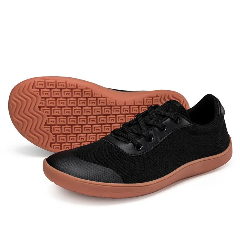 Men's solid-colour training shoes with a mesh upper, wide fit, and ribbed non-slip sole.