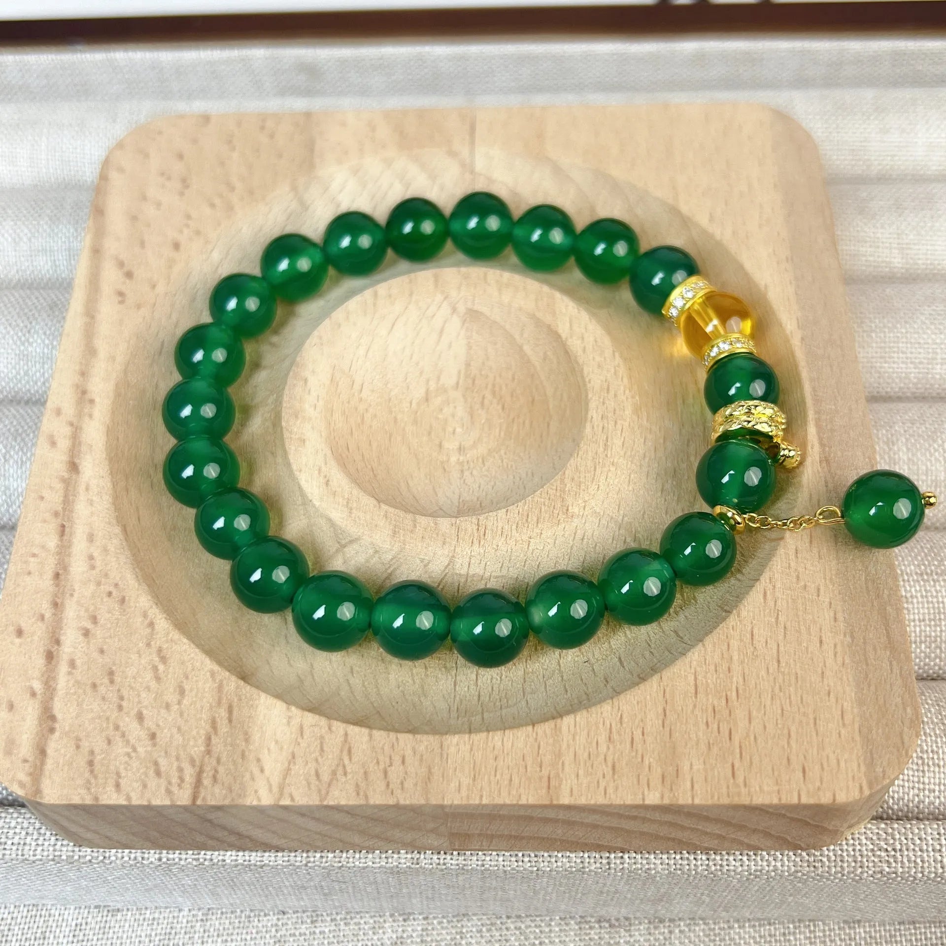 Natural green chalcedony and red agate wealth snake bracelet with copper geometric details.