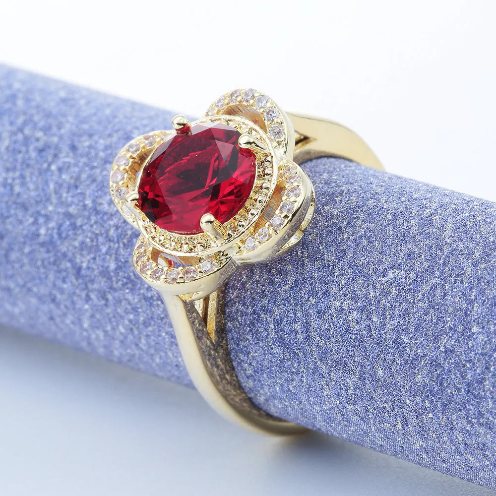 Copper fruit-shaped ring with a zircon stone, shown on a finger.