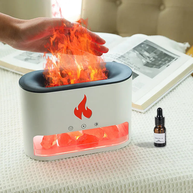 Square white flame humidifier on a desk showing a colourful 3D flame projection and a crystal salt stone.