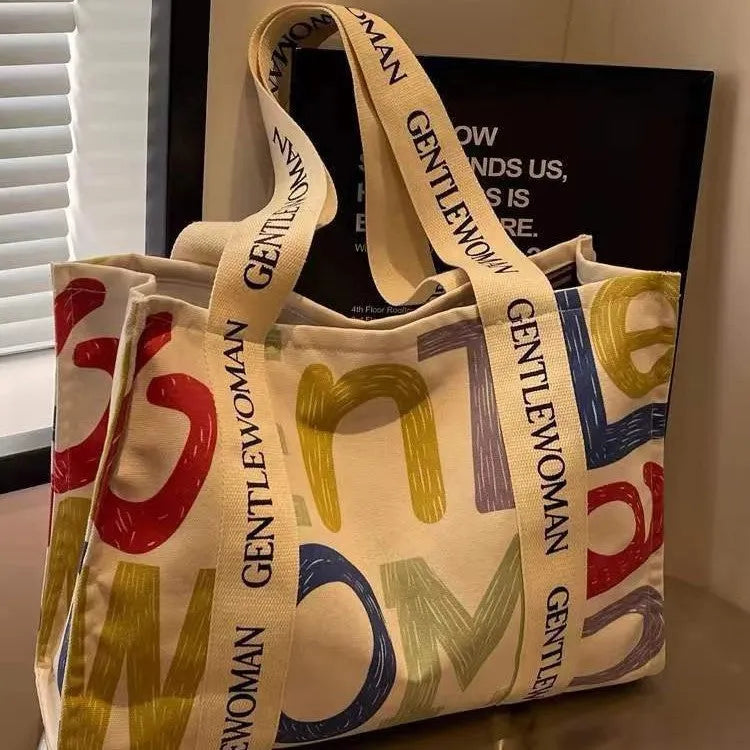 Large canvas women's tote bag with printed design options including letters and patterns