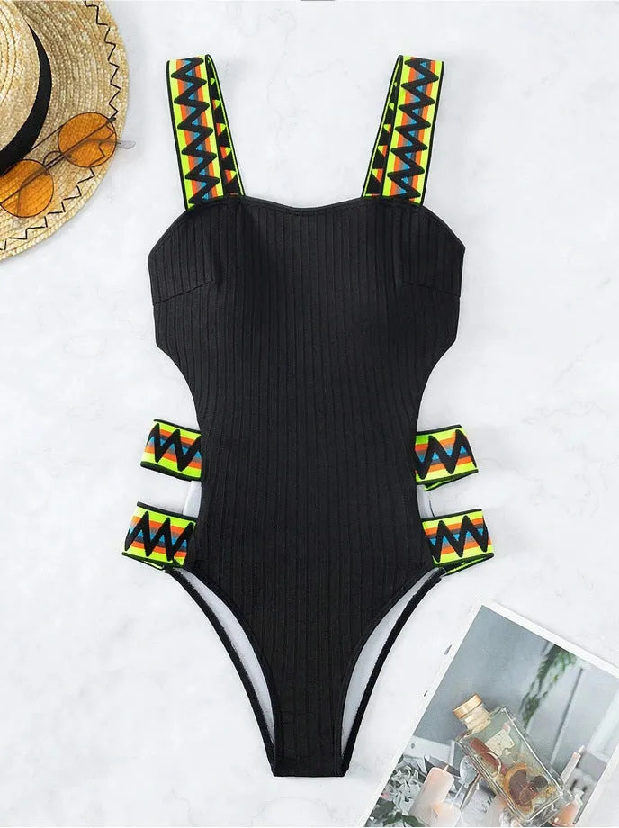 Solid colour black women's one-piece swimsuit made from polyester fabric on a neutral background.