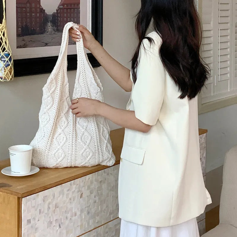 Retro crochet women's tote bag with double shoulder straps in a grass green colour, showing textured knit detail.