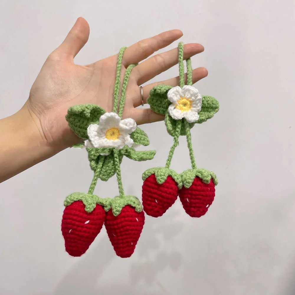 Handmade woven strawberry-shaped car pendant made from cotton and hemp yarn.