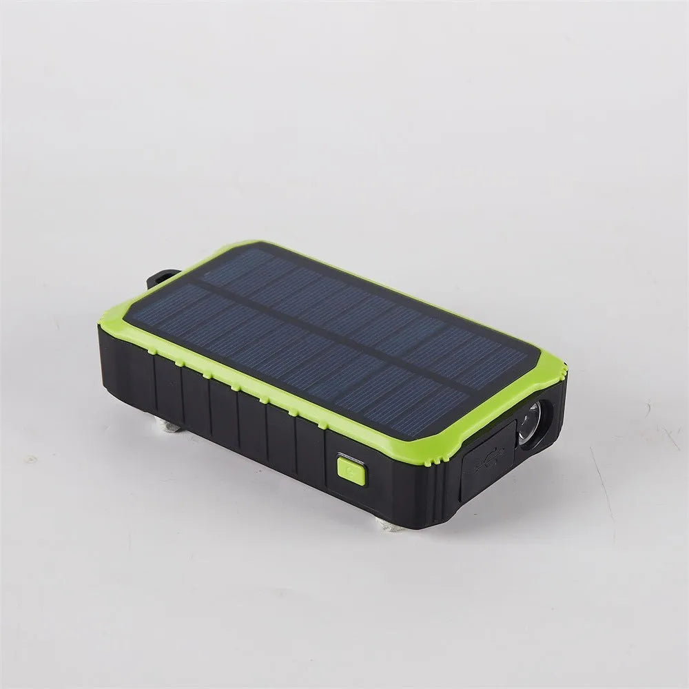 Orange and green portable solar hand crank power bank with USB ports and LED light.