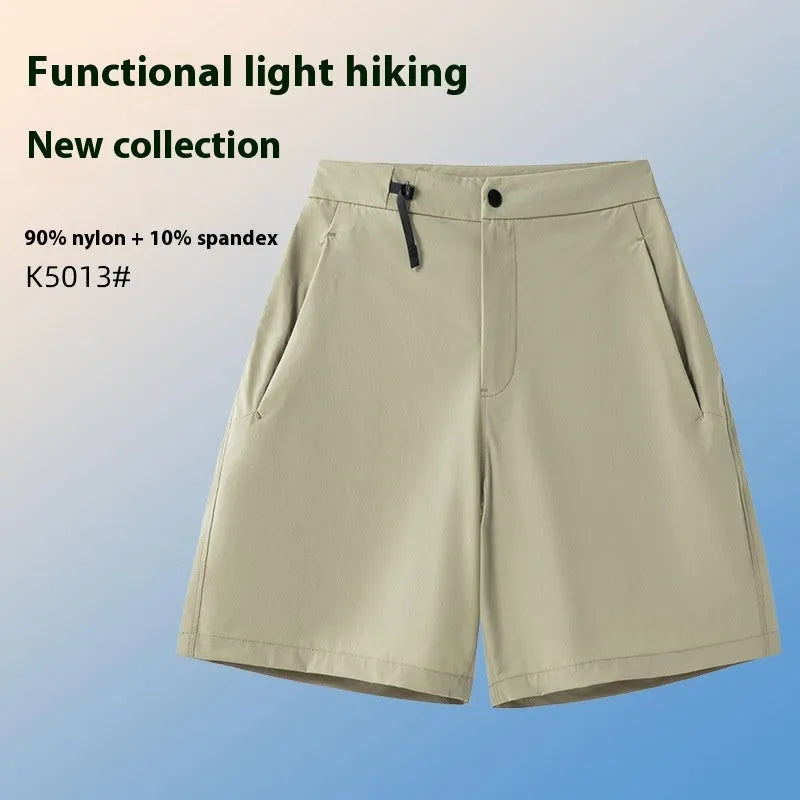 Man wearing khaki athletic shorts with four-way stretch, demonstrating movement for running or climbing.