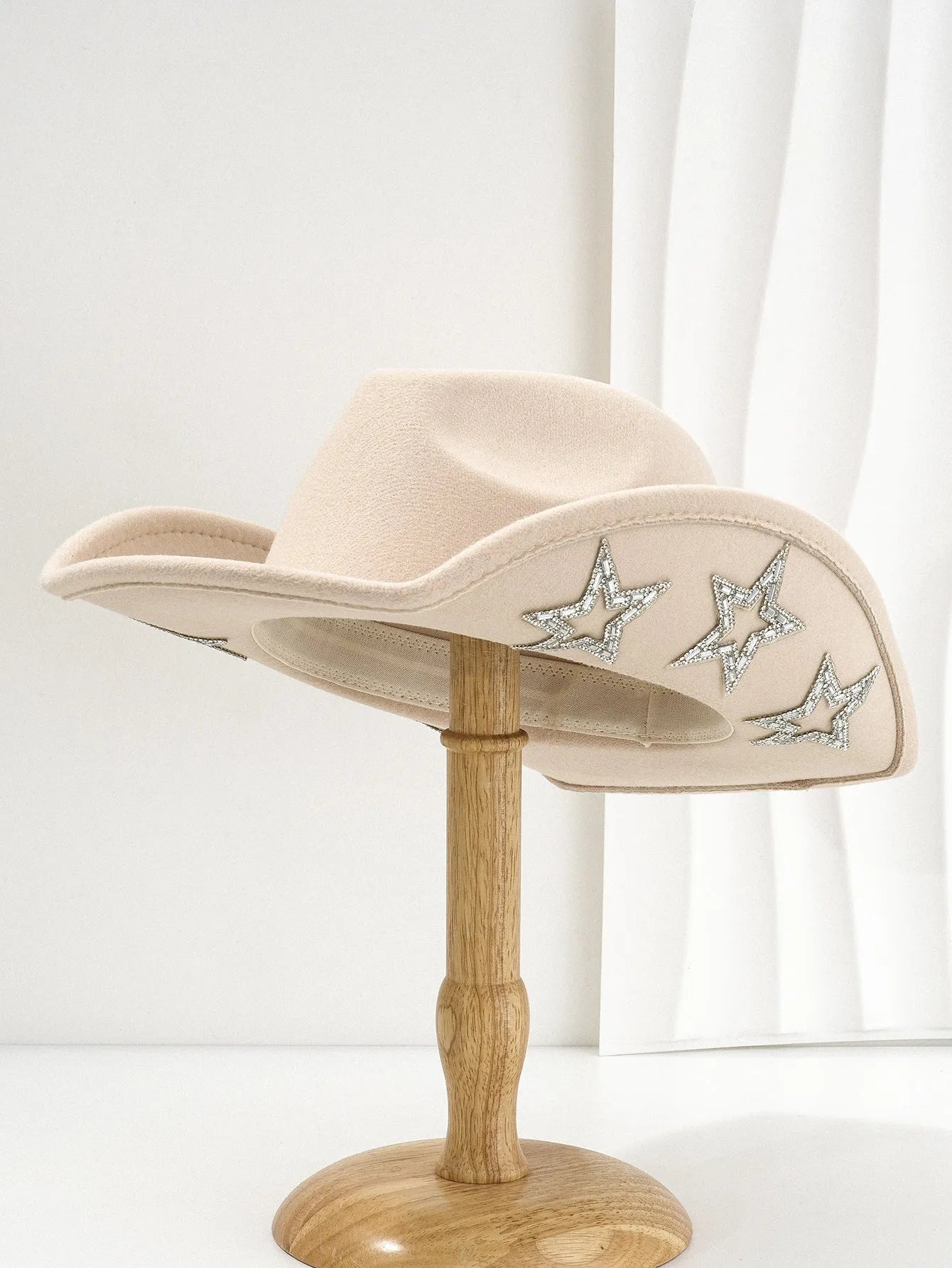 Beige wool felt western cowboy hat with a hexagonal star on the side, conical crown.