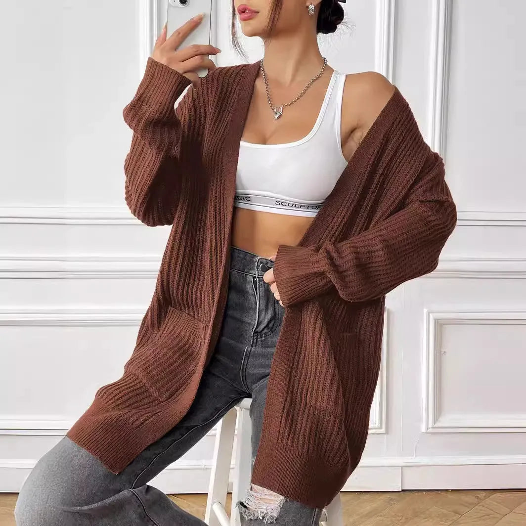 Women's dark green loose cardigan with two front pockets and long sleeves.