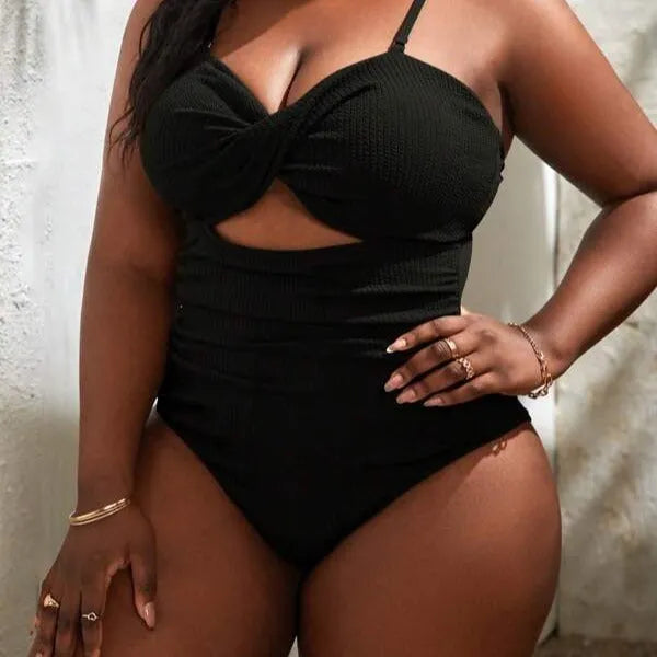 Plus size women's black slimming one-piece swimsuit with triangle sling design