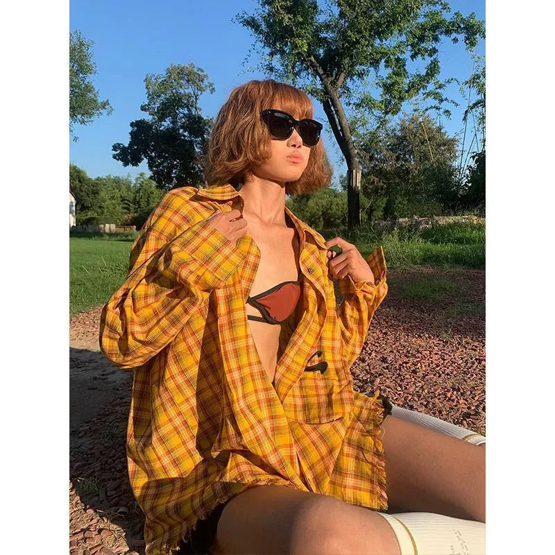 Yellow and white plaid shirt with a loose cardigan fit on a hanger.